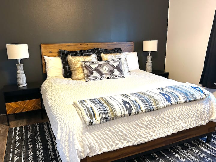 Beautifully styled primary bedroom boasting touch lamps with USB outlets, extra large closet and ensuite bathroom.  All new luxury linens and Nordic Boho vibe will delight guests with style and comfort. 