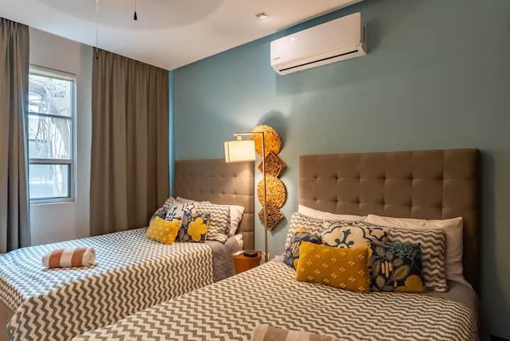 The second bedroom is tastefully decorated with two double beds and a dresser. It also has several large closets.