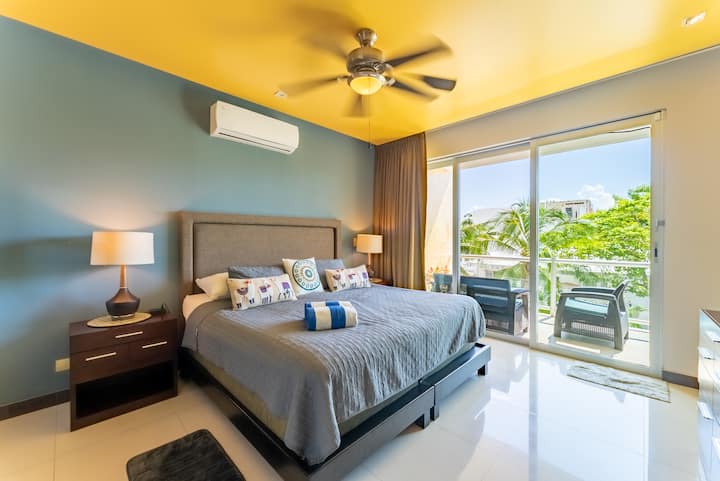 The spacious primary bedroom features a king size bed and ample storage with both closets and a double dresser. Each bedroom has a ceiling fan and A/C unit for comfort. The primary bedoom also has an ensuite bathroom with a large walk-in shower.