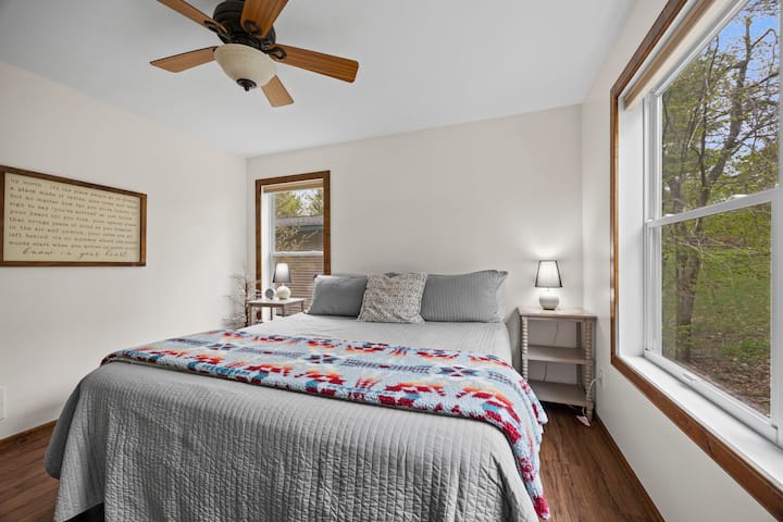 Private king bedroom on main floor is nearby the main floor full bathroom and kitchen and includes extra blankets and pillows with closet space for your belongings. 