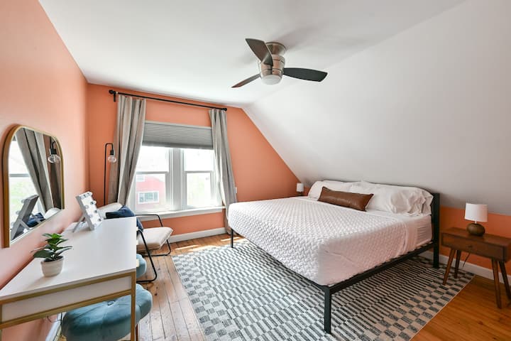 Spacious bedroom with king bed, walk-in closet, and dedicated vanity area.