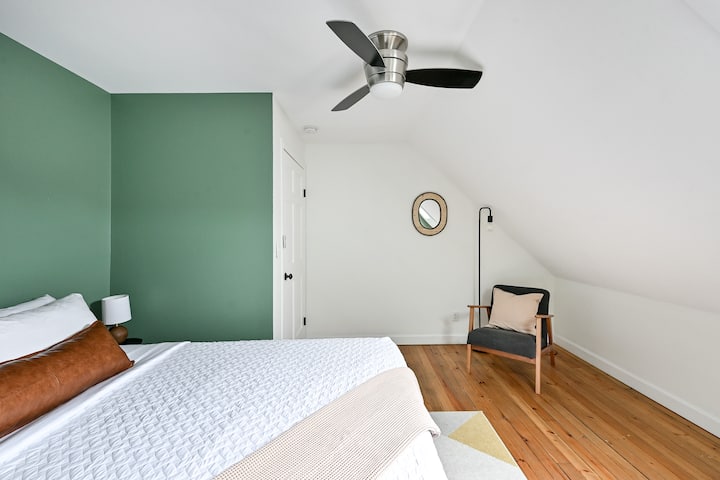 Upstairs queen bedroom with additional seating area.