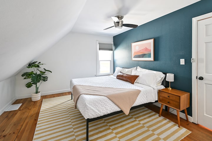 Cozy upstairs king bedroom with blackout blinds, ceiling fan, and closet.