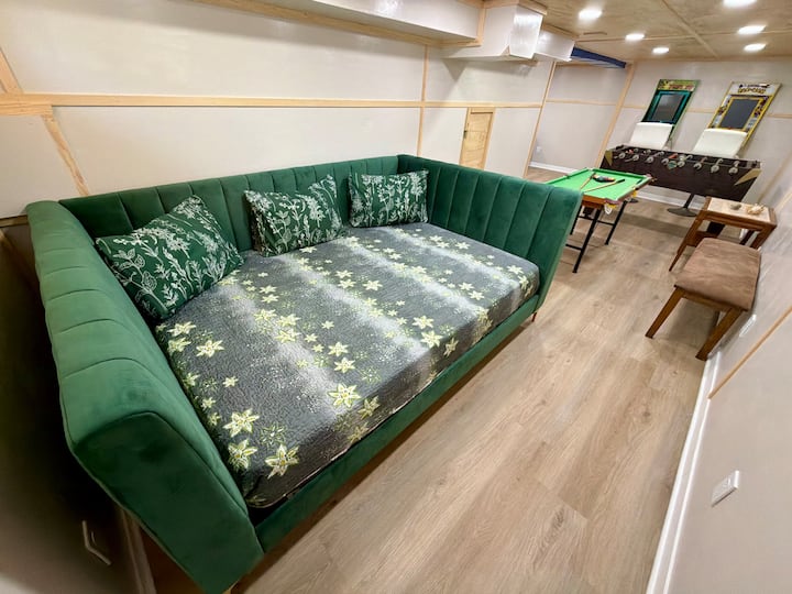 Full sized daybed / at far end of L Shaped basement Game Room ( This is one combined space ! ) 