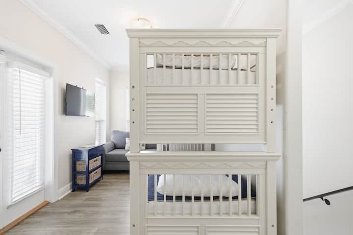 Second floor bunk loft with loveseat, TV, and dresser
