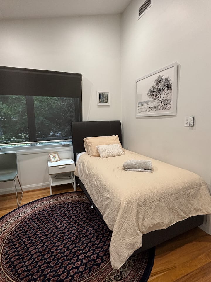 A cosy room with a comfortable king single bed, perfect for accommodating a third guest. Light, quiet, and neatly set up with fresh linens and bedside lighting. If used for a 3rd, an additional $25 p/n applies to cover breakfast supplies/tea coffee