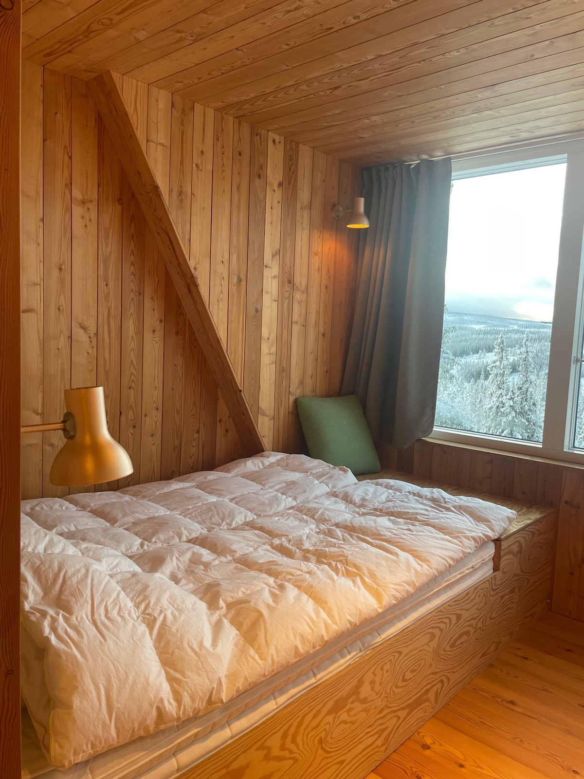 This bedroom has one double bed and one single bed and includes bed side lamps, a small sofa / seating area for relaxing, reading books. The room has a sliding door. A open closet exists just outside, so no need for having clothes in the bedroom