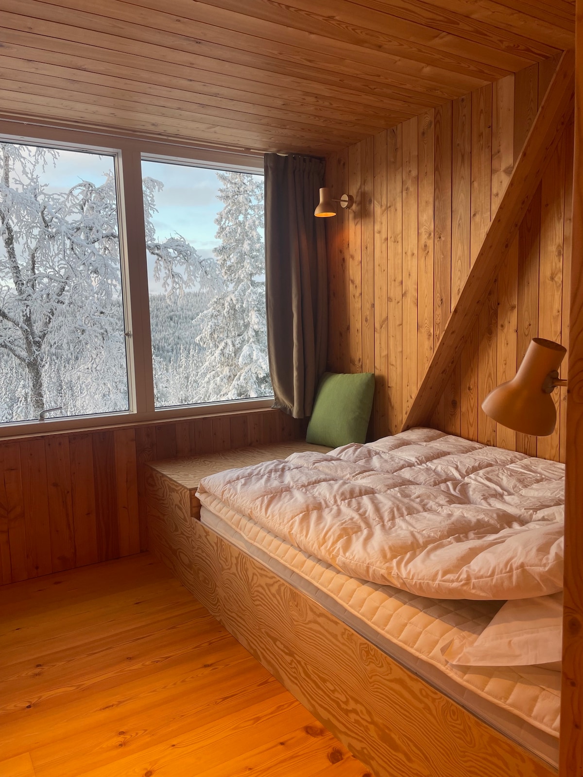 This bedroom has one double bed and one single bed and includes bed side lamps, a small sofa / seating area for relaxing, reading books. The room has a sliding door. A open closet exists just outside, so no need for having clothes in the bedroom