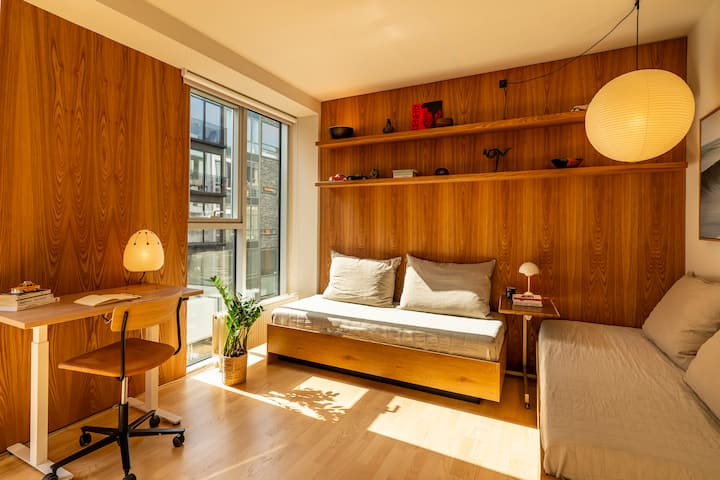 Our bedroom lined with floor-to-ceiling in handpicked red elm. Wake up with views onto the canal