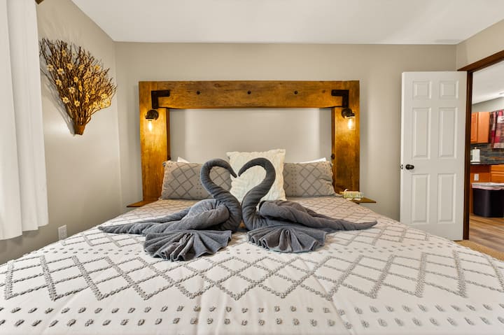 Master Bedroom – Unwind in the spacious primary suite featuring a king bed, custom rustic headboard, plush linens, ample closet space, and a private ensuite bathroom for added comfort and convenience.