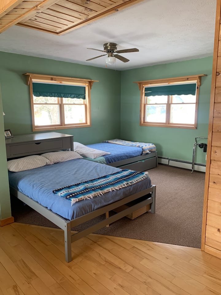 The open concept loft area includes three full size beds, one twin trundle, and the convertible queen couch. This space is open to the living room below.