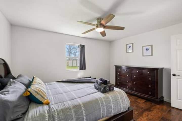 Your peaceful bedroom features beautiful hardwood floors, a cozy ceiling fan, and thoughtfully arranged linens for restful nights.
