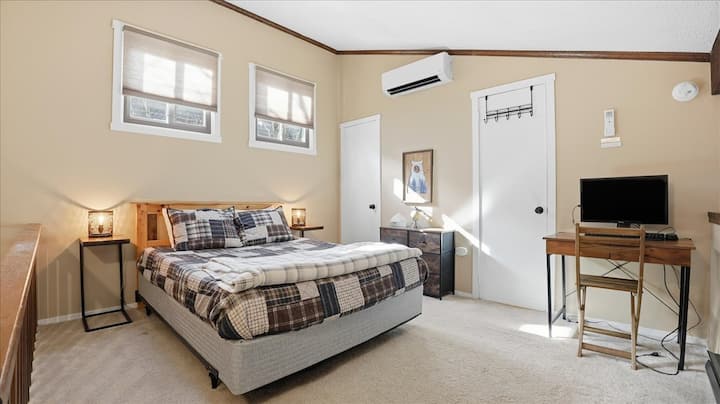 Queen bed located in loft, with a dresser for storage. Full bathroom attached.