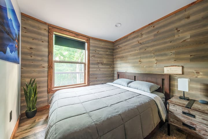 Bedroom #2 with storage, hangers, shelves, comfortable queen size bed, height-adjustable pillows, and USB A and C charging ports
