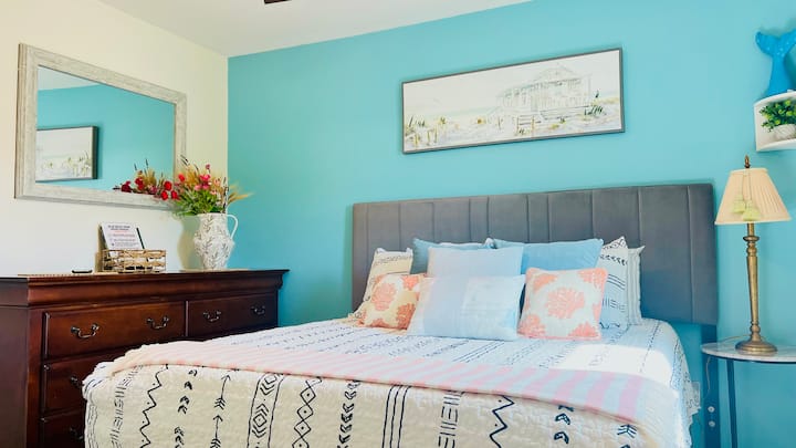 Sunny second bedroom with blackout curtains on the second floor with Queen mattress and foam topper.