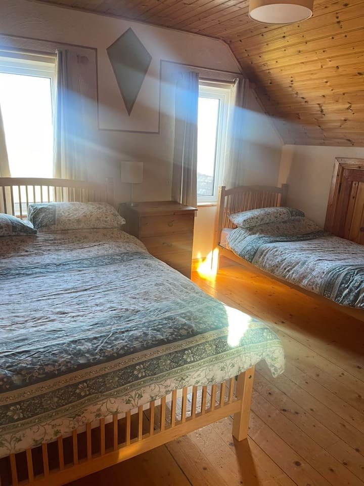 Bedroom 2 is upstairs. It has one double bed and one single bed and its own ensuite