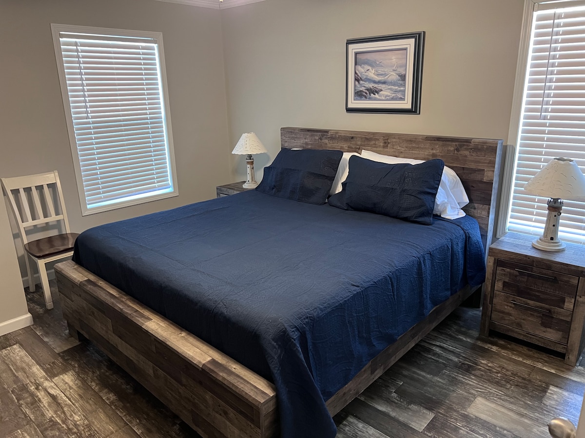 Master bedroom with king bed and TV