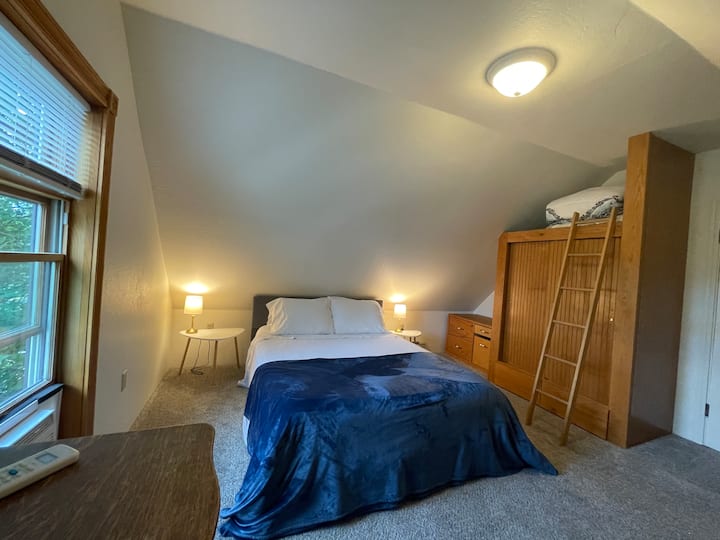 West bedroom has a queen bed and lots of storage space for your clothing. Also has a chair for reading as you take in the view of Mount Helena.
