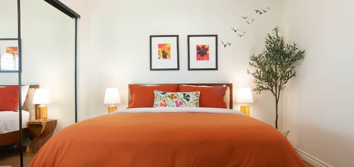 Vibrant orange hues, elegant decor, and warm lighting for restful nights!