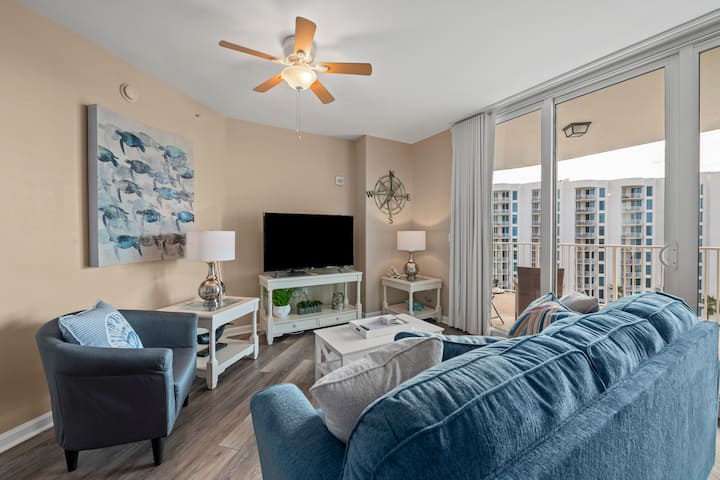 Living room with a Queen sofa sleeper and sliding doors out to your balcony with both Gulf and Lagoon Pool views, Large Flat screen TV for lounging after a day at the beach or pool.