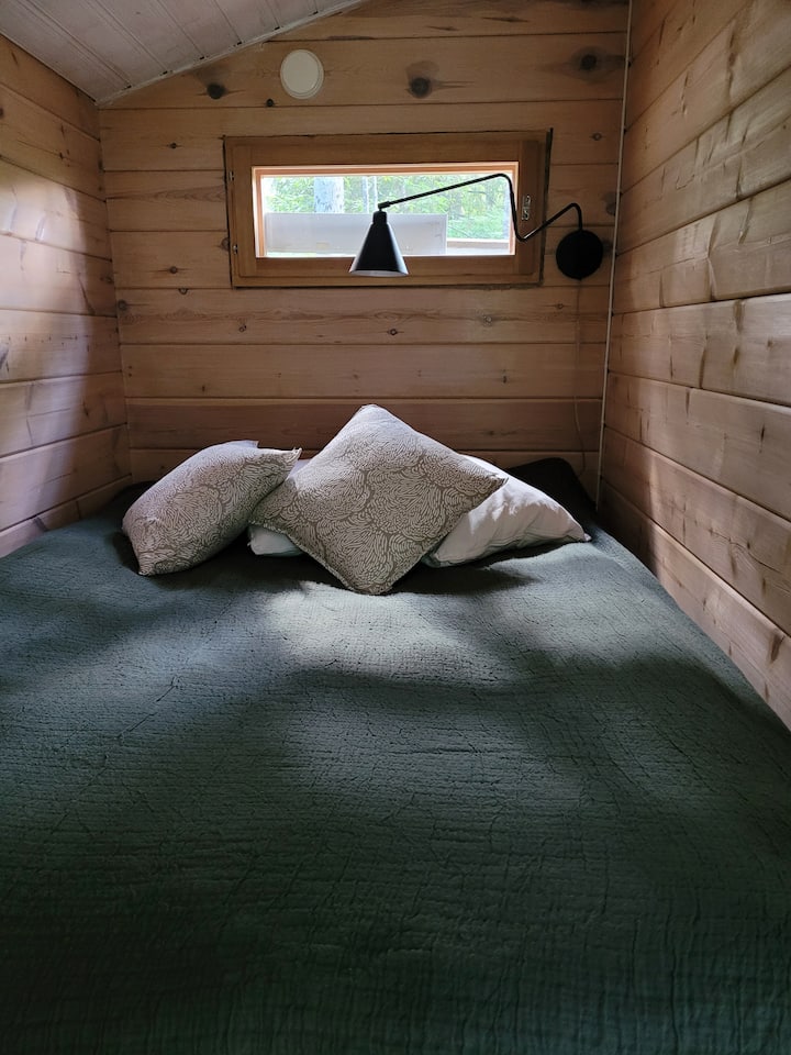 客用小屋的卧室空间，配备140厘米宽的床。 