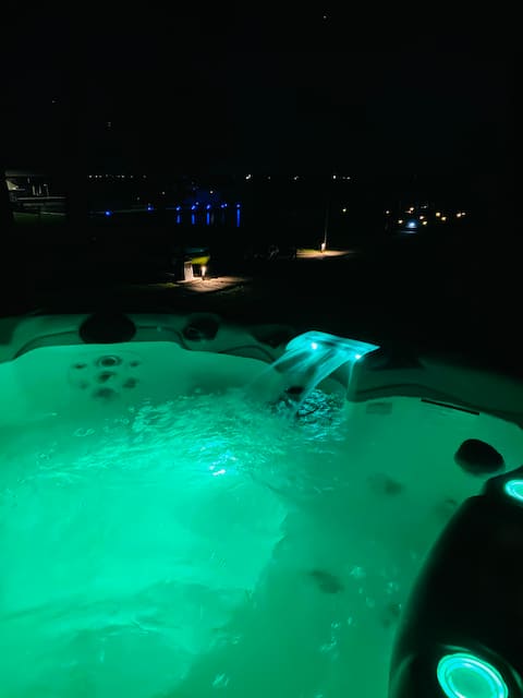 Open water view: cozy hot tub & fire pit with dock