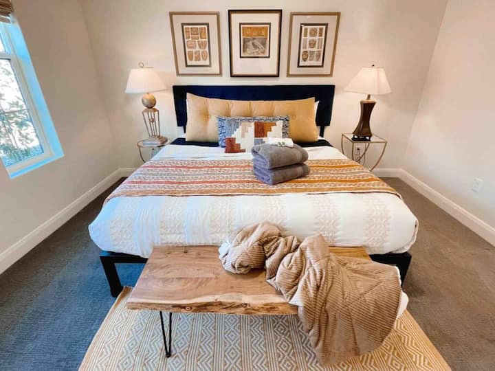 Master bedroom with a king size bed and en suite bathroom; downstairs.
