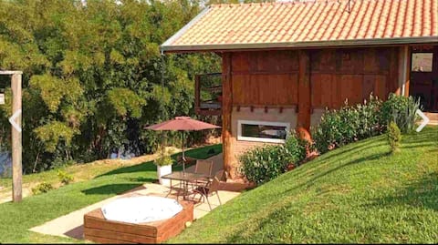 Romantic cabin with a hot tub, surrounded by nature.