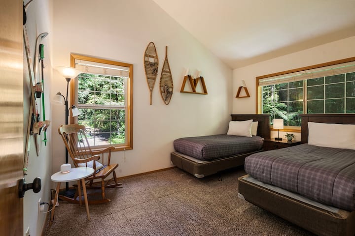 Guest bedroom with two twin beds.  Reading nook with rocking chair.  Pack & play and bedrail in spacious closet.