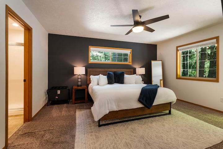Master bedroom on the main floor.  Tuft & Needle luxury king bed with premium bedding. Walk-in closet, dresser, 55" Smart TV, ceiling fan, access to back deck, on-suite bath