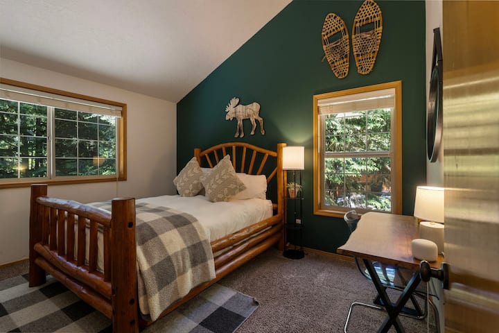 Queen log bed frame with premium bedding.  Bedroom on 2nd floor. 
Spacious closet + dresser.
Dedicated workspace with live edge desk top.