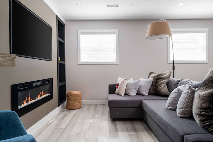 Spacious living room with electric fireplace & L-shaped sectional near Western University