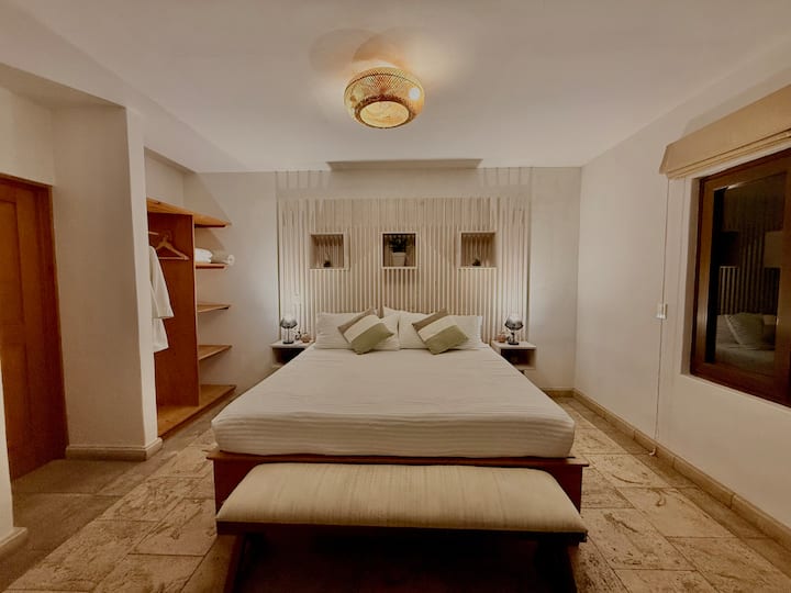 Comfortable king bedroom with workspace

