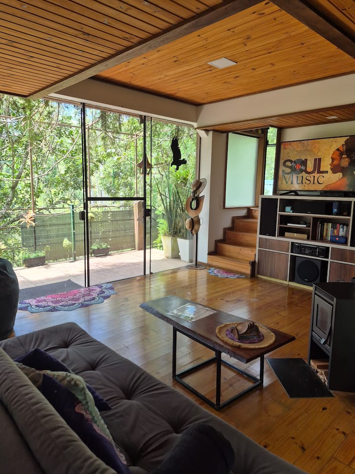 Nossa sala de estar é rodeada por vidros, garantindo essa vista panorâmica incrível. E o melhor: você curte a natureza com total tranquilidade, já que instalamos telas protetoras em todas as aberturas para manter os insetos indesejados lá fora.