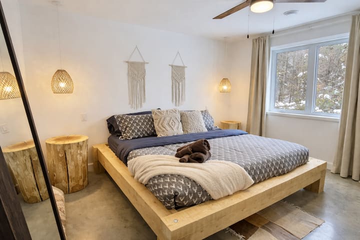 Master bedroom located upstairs. King size bed and top mattress. 