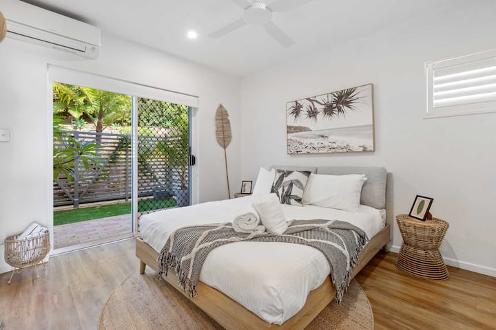 Two bedrooms open directly onto a private courtyard filled with natural light