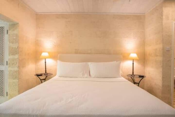 Calm and sophisticated en suite US king size bedroom with ample clothes storage and a private balcony.
