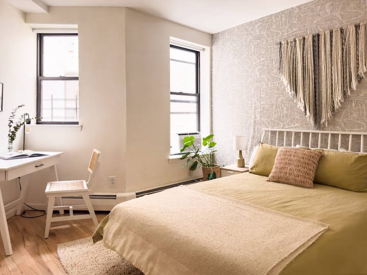 Spacious secondary bedroom with queen size bed, large closet, and a workspace.