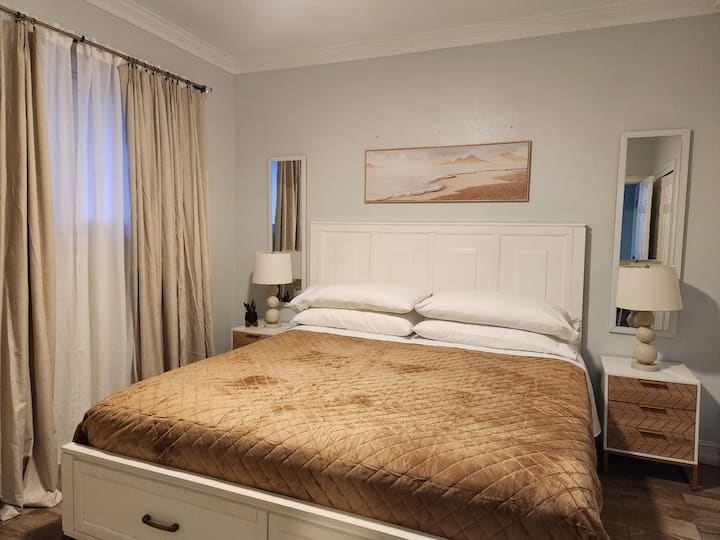 Premium King bedroom with premium bedding, blackout curtains, and modern farmhouse decor
