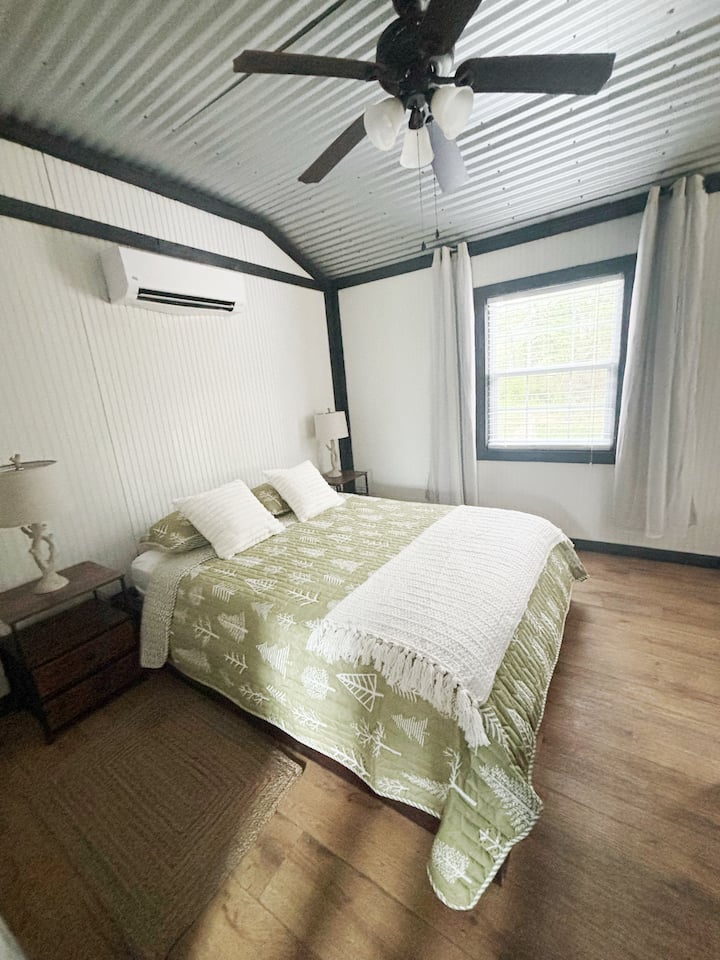 Queen sized bed in the bedroom area.