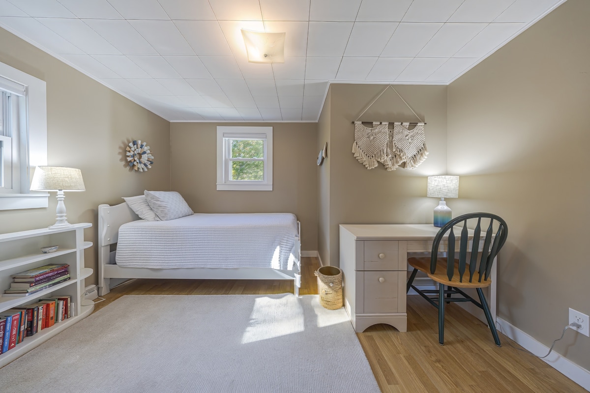 A cozy twin bed tucked into a streamside nook - fall asleep to the sound of the brook and wake up to birdsong. Our desk provides a mini-office space if you must tend to business.