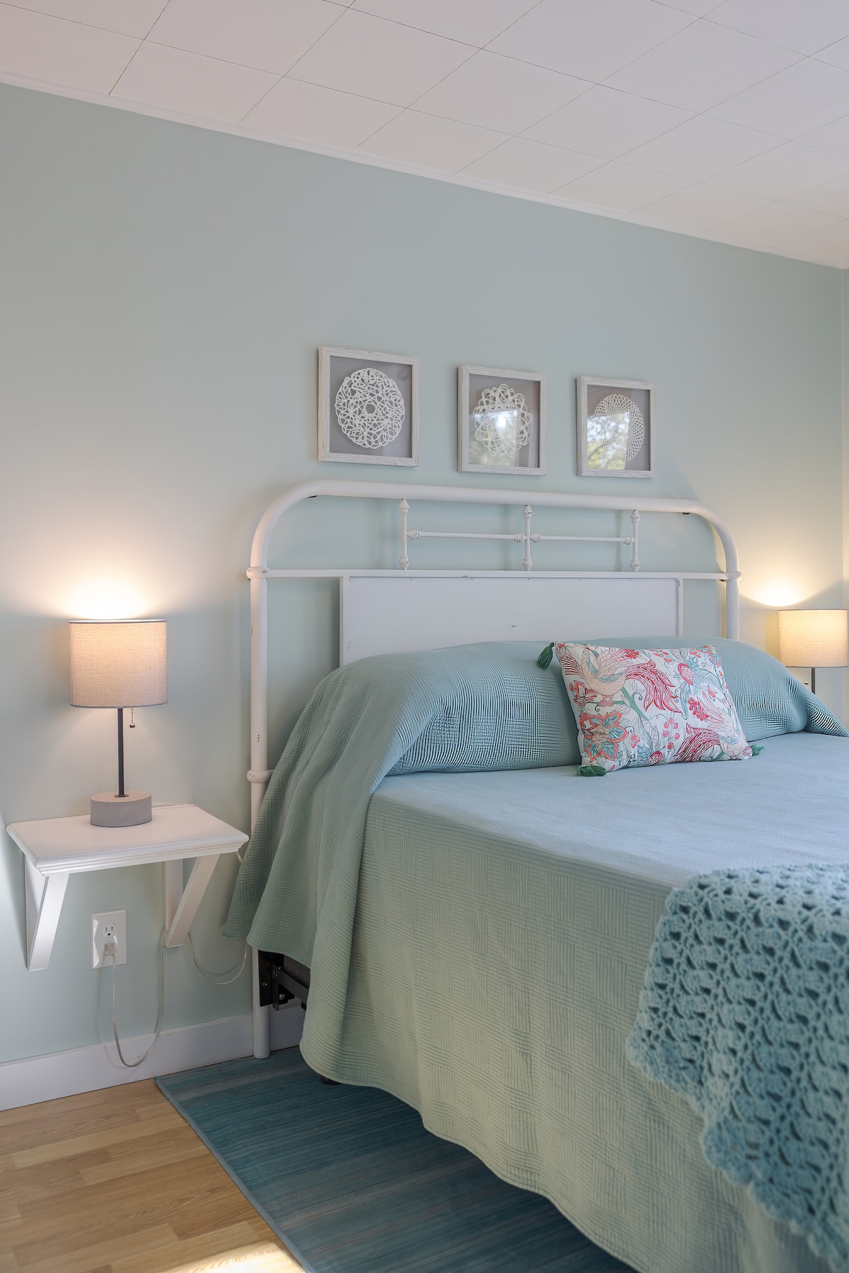 This room has an overhead light plus a small lamp on each side of the bed, plus a small table for your books and things.