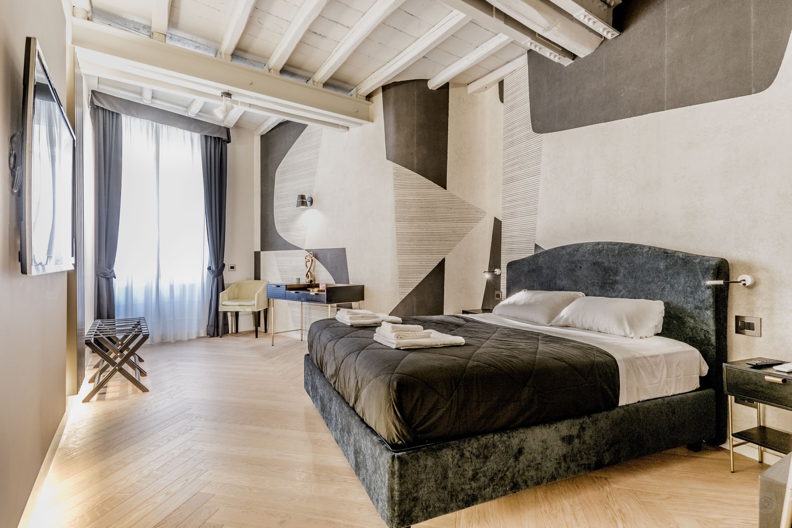 Spacious living room with high ceilings and original coffered details in the Spanish Steps design loft