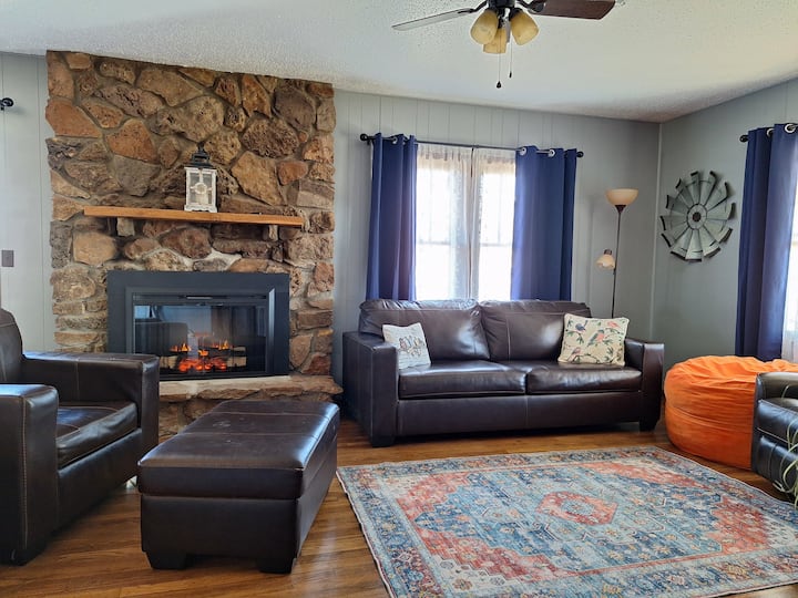 The living room features a queen-size sofa bed and electric fireplace.
