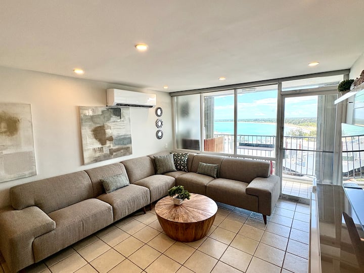 Spacious and comfortable living room with ocean views. 