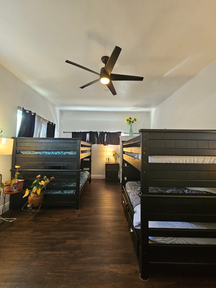 'The Dorm' has 4 full size beds in a bunk bed style. You can see 2 beds on the right and 2 beds on the left. Plus 'The Dorm' has a private bathroom