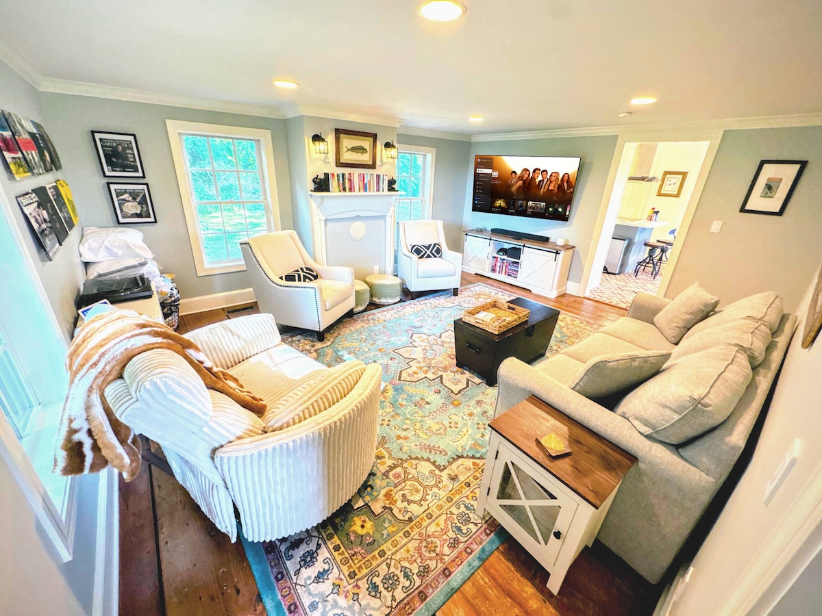 The living room seats the whole family and features a vinyl record collection, Xbox Series X, and 65″ smart TV with Dolby Atmos sound. The soundbar and sub connect to the home’s smart speaker system for immersive movie nights or music playback.