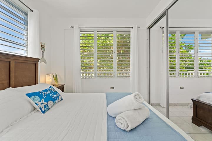 Master Bedroom: Bright and inviting, featuring lush views and stylish coastal decor for relaxation.