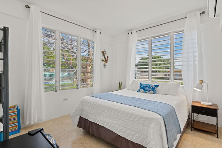 Bright Bedroom: Revel in light-filled comfort with charming decor and serene views!