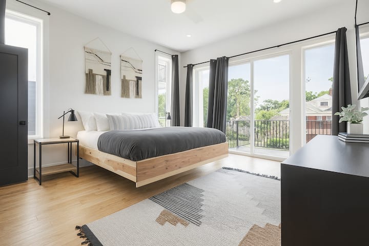 Primary bedroom suite with private balcony & downtown views. You can see the iconic Batman building from the comfort of your own bed!